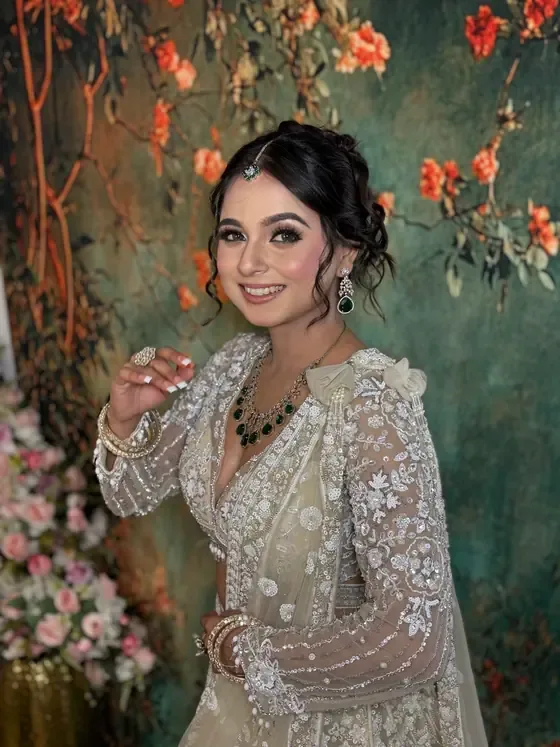 Bride in ivory and silver against a painted floral backdrop