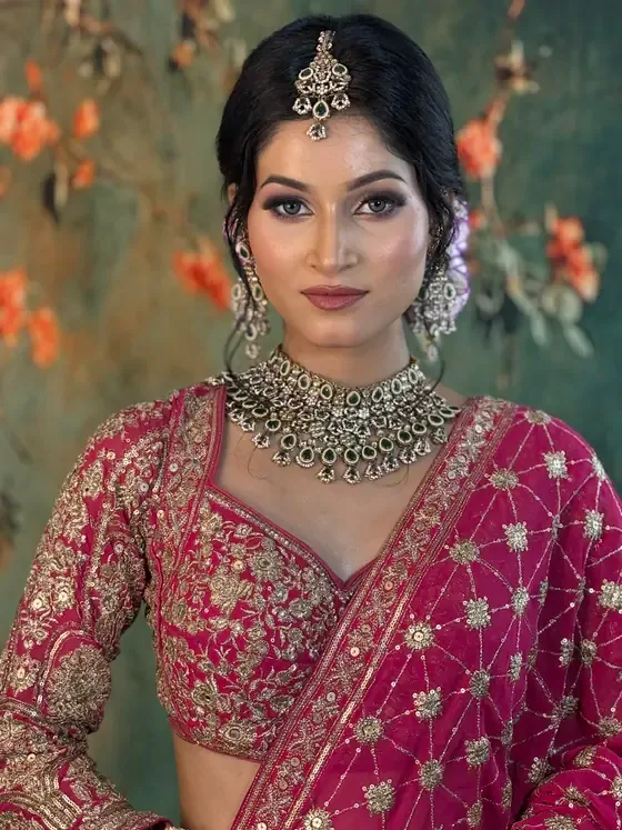 Close portrait of a bride in magenta with a maang tikka