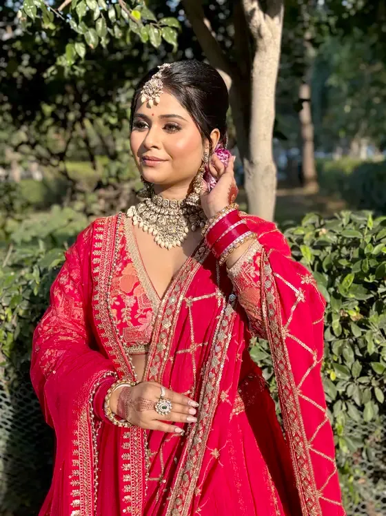Bride in scarlet photographed outdoors in daylight