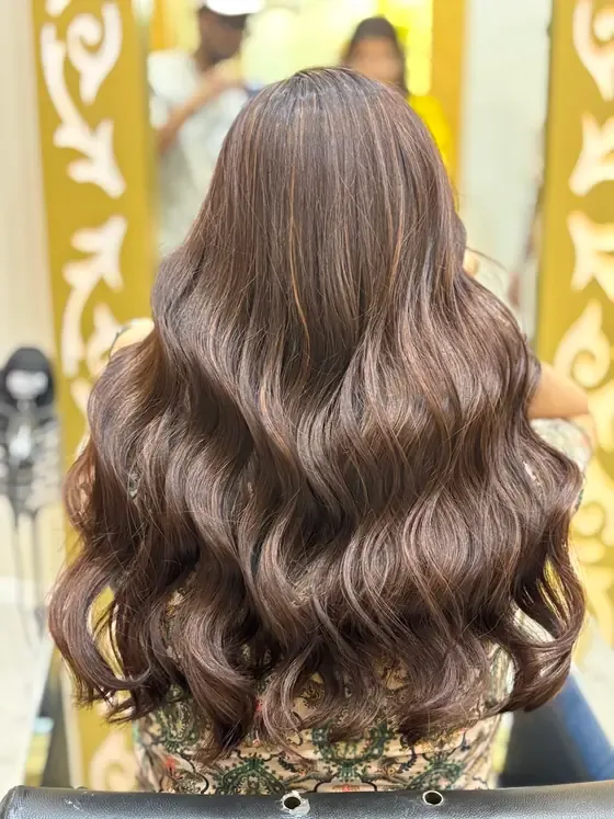 Balayage colour with long soft waves, photographed from behind