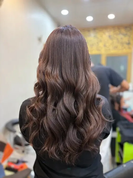 Deep brunette global colour with a soft wave set