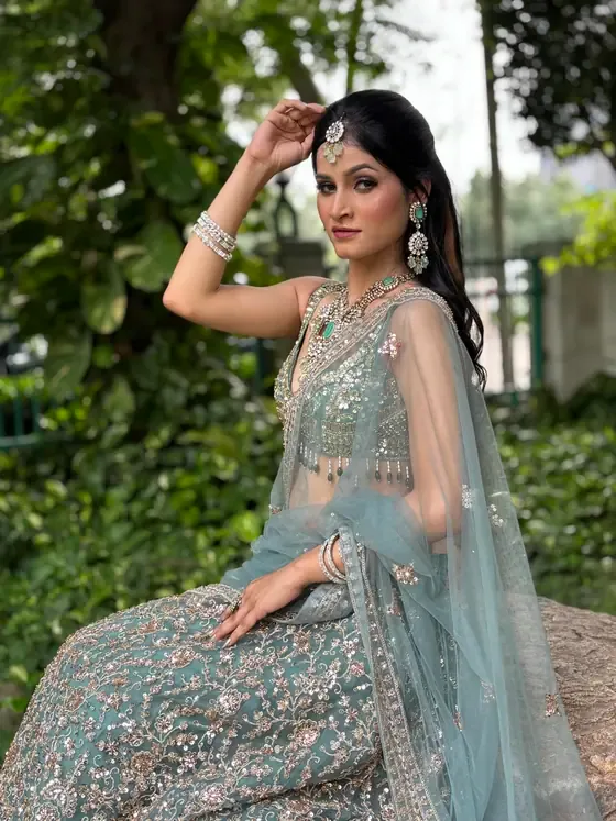 Client in a blue lehenga with silver jewellery