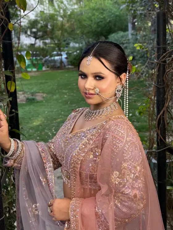 Close portrait in blush with a maang tikka