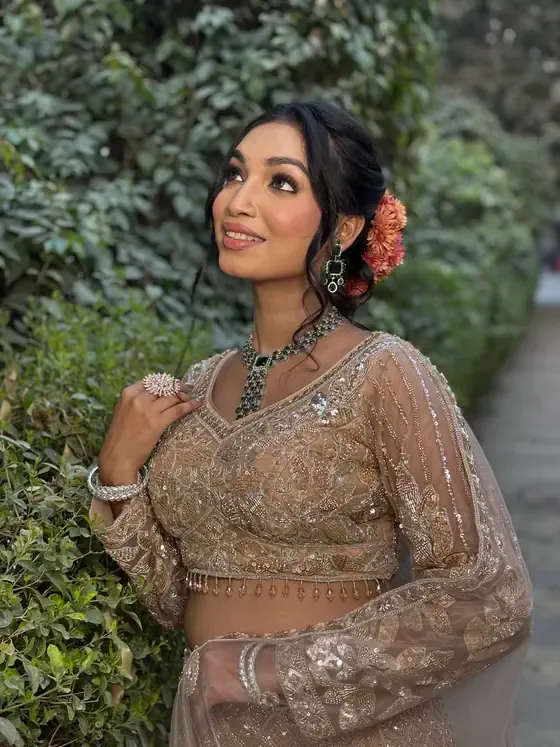 Occasion look in beige and gold, photographed outdoors