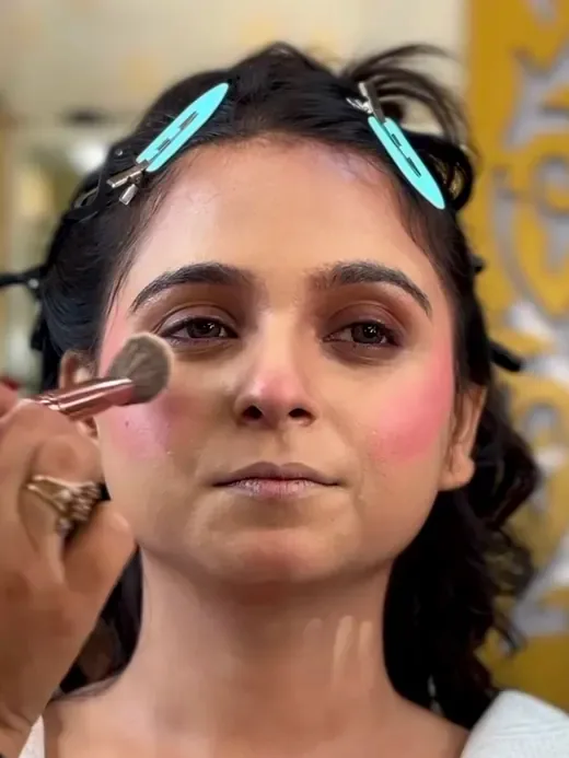Makeup being applied in the studio chair, checked in daylight